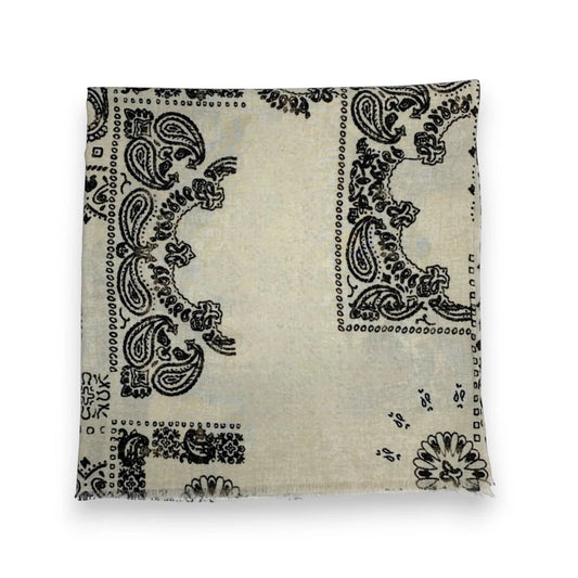 Eclectic cream wool blend scarf featuring a black oversized bandana paisley print with a soft frayed edge finish.