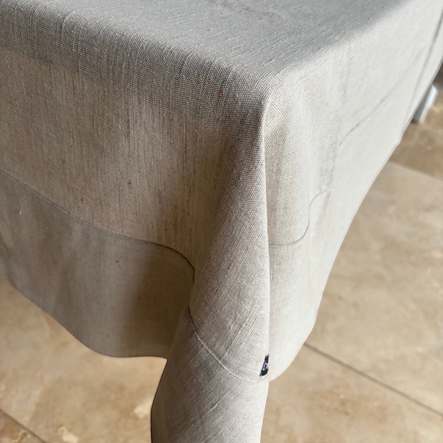 Eclectic Daiva Lino natural stone linen and cotton blend tablecloth with a soft woven texture draped over a table.