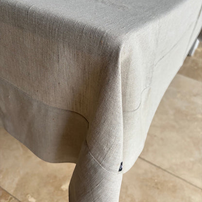 Eclectic Daiva Lino natural stone linen and cotton blend tablecloth with a soft woven texture draped over a table.
