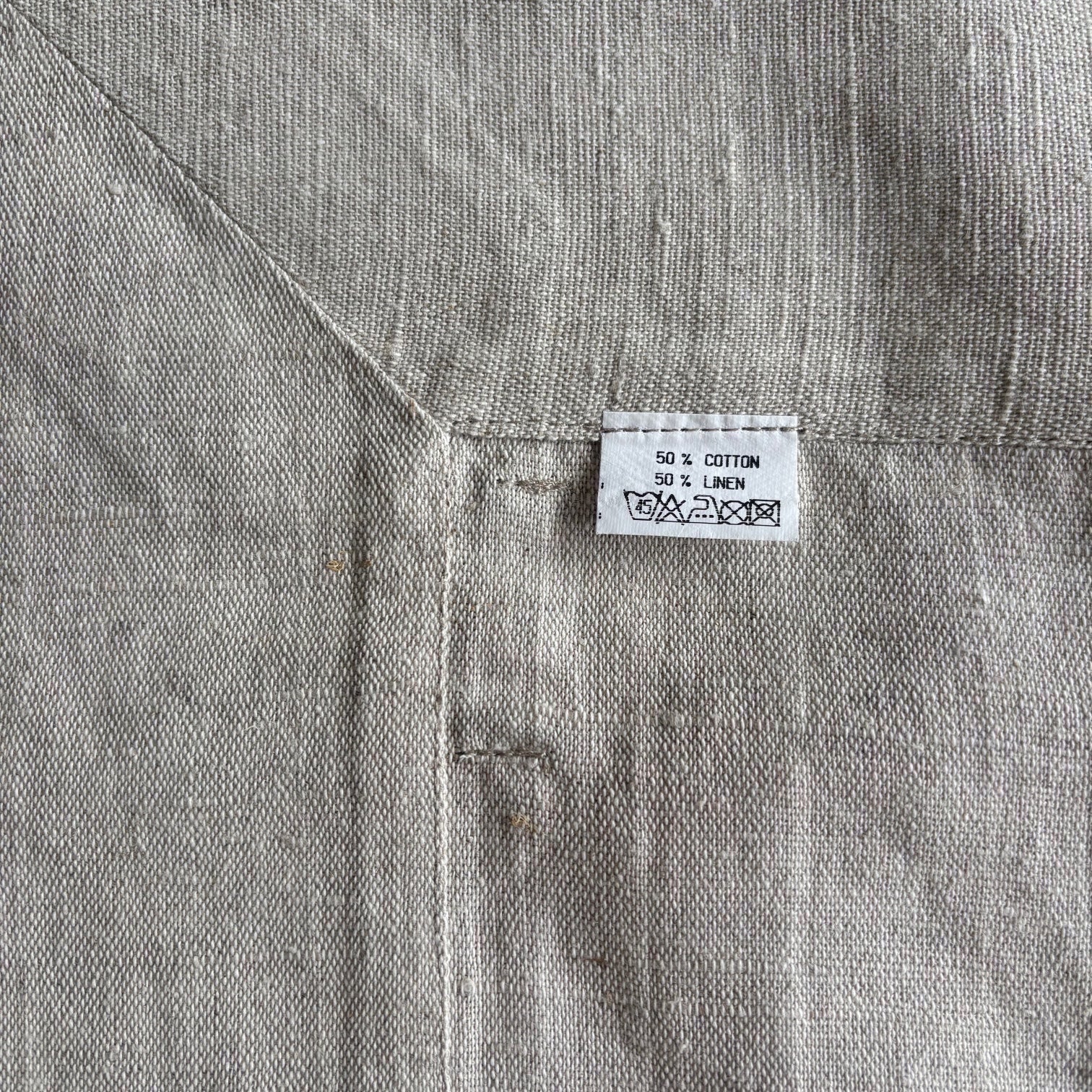 Eclectic Daiva Lino natural stone coloured linen cotton blend tablecloth with visible woven texture and care label