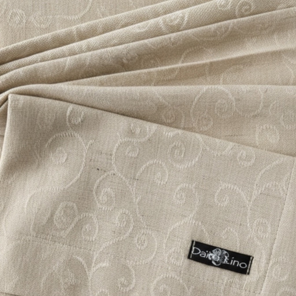 Eclectic Daiva Lino natural stonewashed linen napkin with a delicate tonal scroll pattern and fabric label detail.