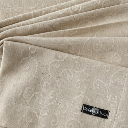 Eclectic Daiva Lino natural stonewashed linen napkin with a delicate tonal scroll pattern and fabric label detail.