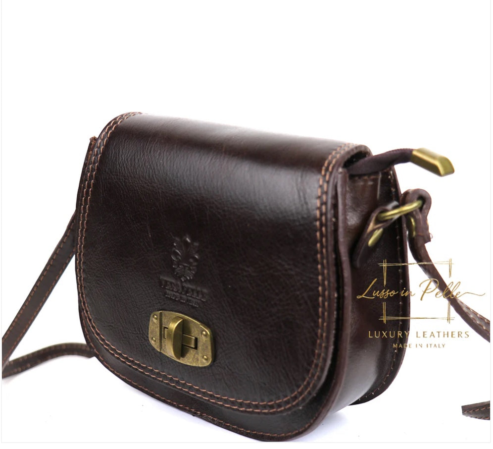 Eclectic dark brown Italian leather crossbody bag with brushed brass twist-lock hardware and adjustable shoulder strap