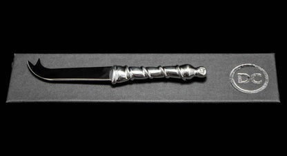 Eclectic Diana Carmichael Ribbon pewter cheese knife with a vine-inspired handle, presented in a branded gift box.