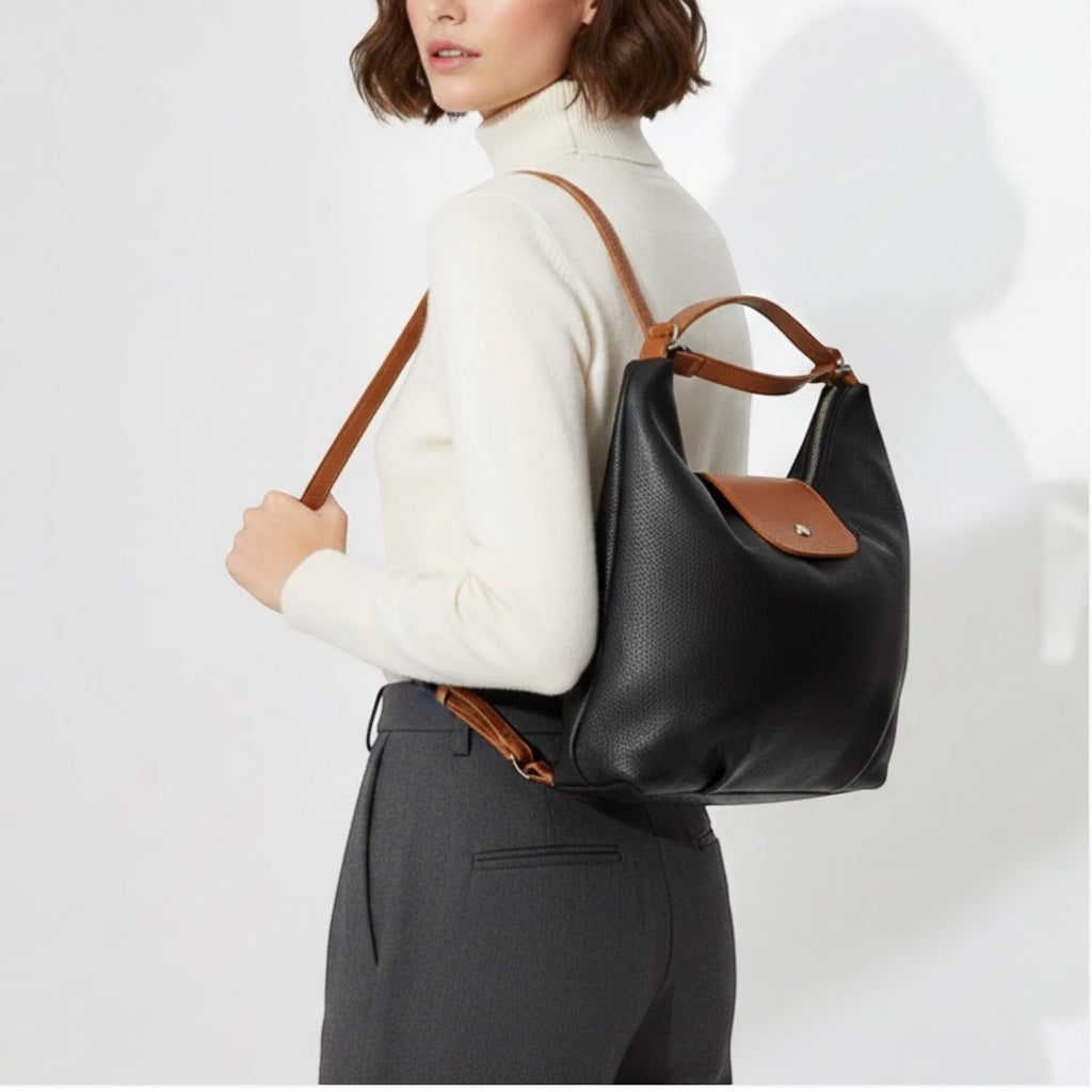 Eclectic Donatello Duo black grain leather convertible backpack worn by a woman with tan straps and silver hardware
