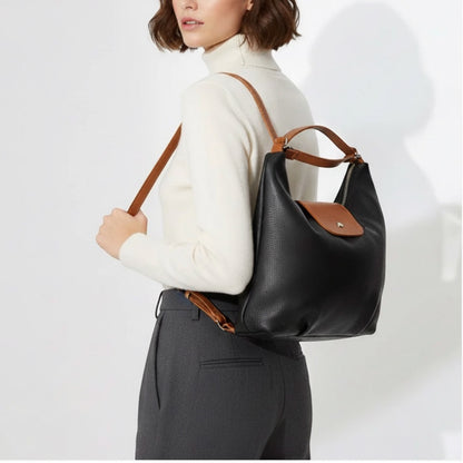 Eclectic Donatello Duo black grain leather convertible backpack worn by a woman with tan straps and silver hardware