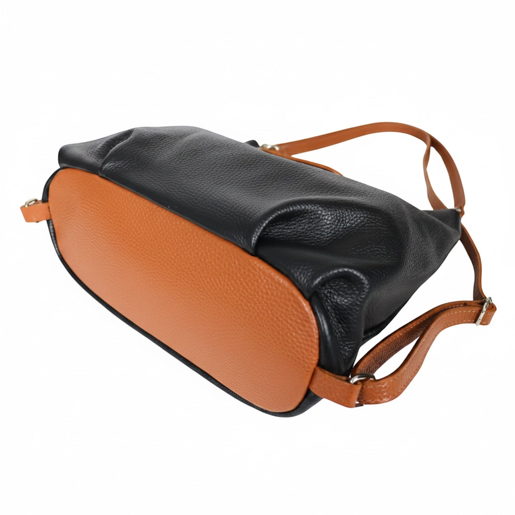 Eclectic Donatello Duo convertible bag in black and tan grain leather with adjustable straps on a white background.