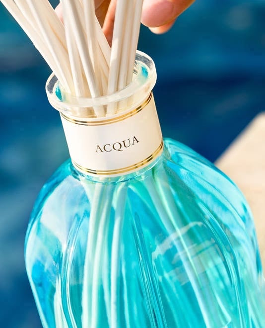 Eclectic Dr Vranjes Acqua reed diffuser in a vibrant blue glass bottle with natural sticks for home fragrance