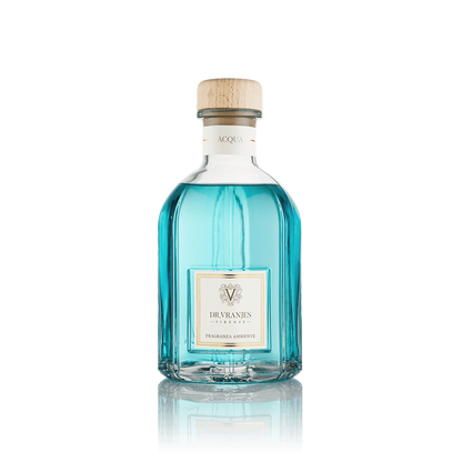 Eclectic Dr Vranjes Acqua reed diffuser in a clear glass bottle with blue fragrance liquid and a wooden cap.