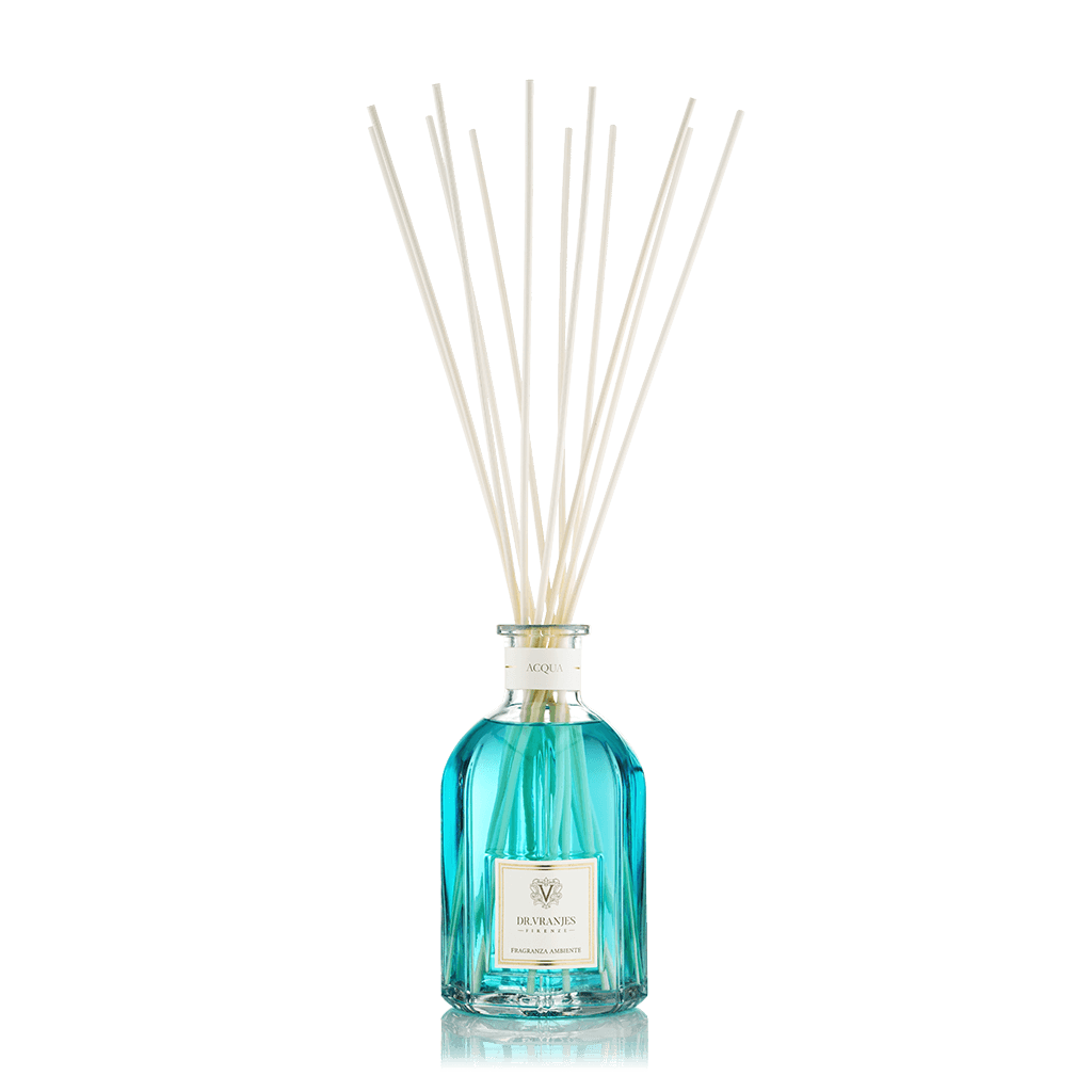 Eclectic Dr Vranjes Acqua reed diffuser in a blue glass bottle with natural sticks against a black background.
