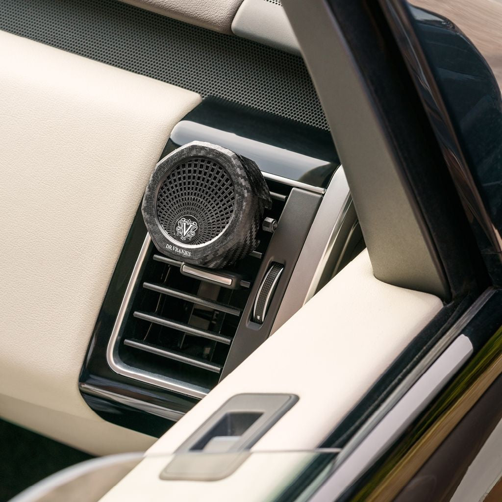 Eclectic Dr. Vranjes Carparfum diffuser with a carbon fibre finish clipped onto a luxury car air vent.