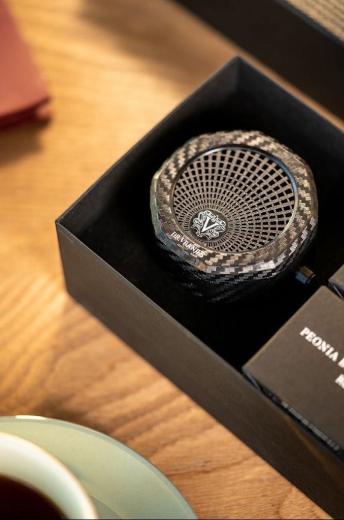 Eclectic Dr. Vranjes carbon fiber car air vent diffuser with octagonal design inside a gift box.