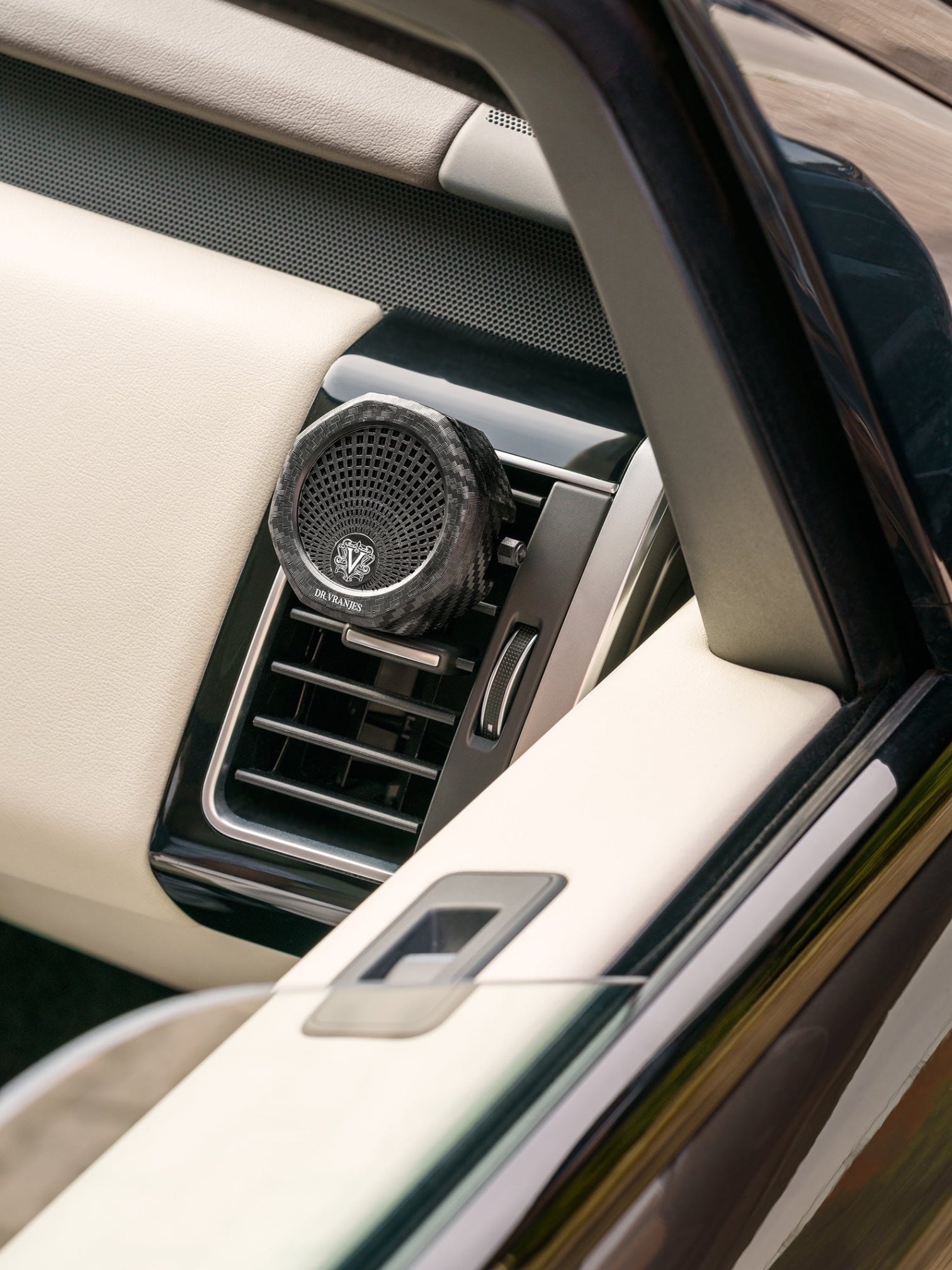 Eclectic Dr Vranjes carbon fibre car air vent diffuser with octagonal design mounted in a luxury car interior