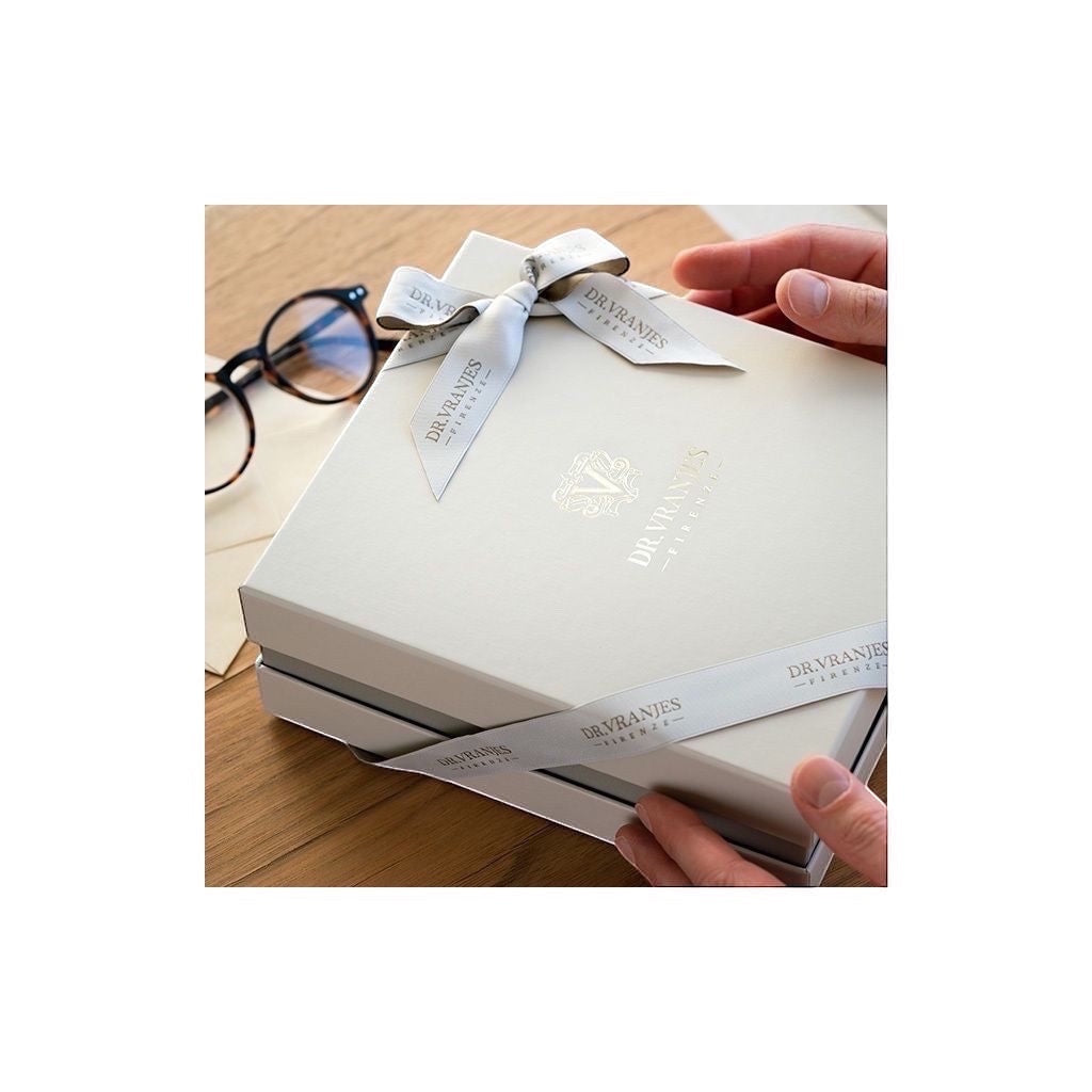 Eclectic Dr. Vranjes Rosso Nobile luxury gift set box tied with a branded ribbon on a wooden table.