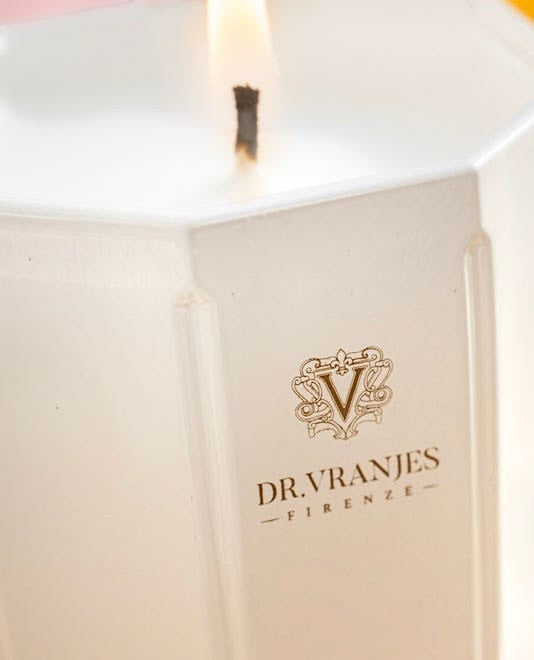 Eclectic Dr. Vranjes Ginger Lime scented candle in a pearl-coloured glass vase with a lit wick