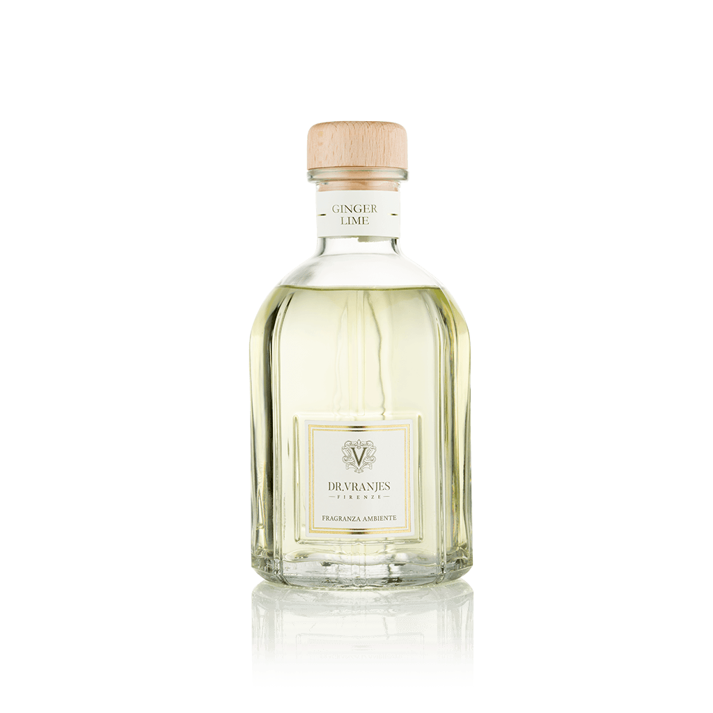 Eclectic Dr Vranjes Ginger Lime reed diffuser in a clear glass bottle with a wooden cap against a black background.