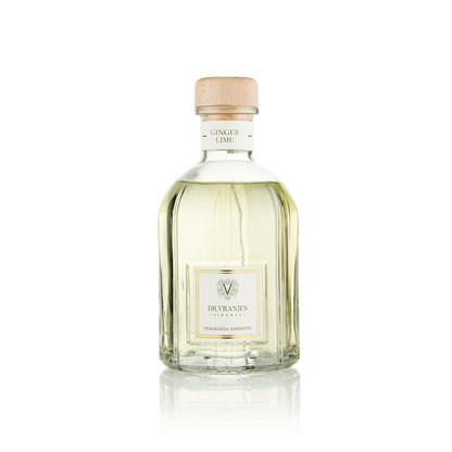 Eclectic Dr Vranjes Ginger Lime reed diffuser in a clear glass bottle with a wooden cap against a black background.
