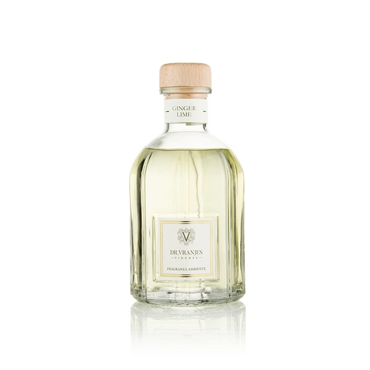 Eclectic Dr Vranjes Ginger Lime reed diffuser in a clear glass bottle with a wooden cap against a black background.