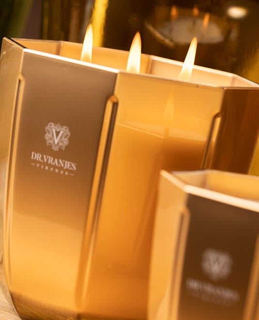 Eclectic Dr. Vranjes Oud Nobile scented candle in a luxurious gold-coloured glass vase with three burning wicks.