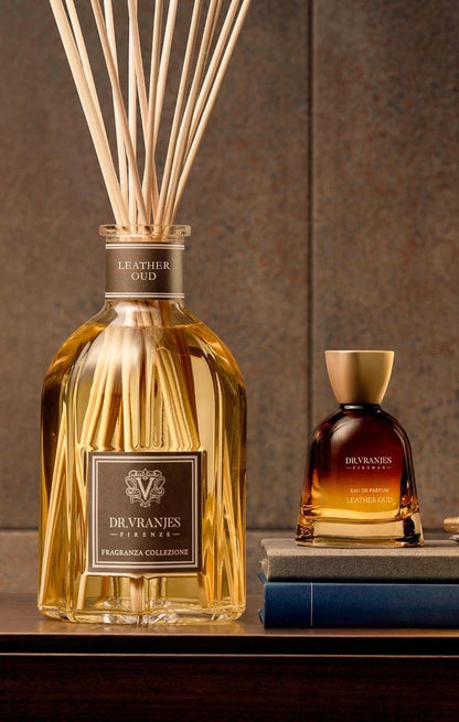 Eclectic Dr Vranjes Leather Oud reed diffuser and perfume bottle set on a wooden surface with a warm, elegant backdrop.