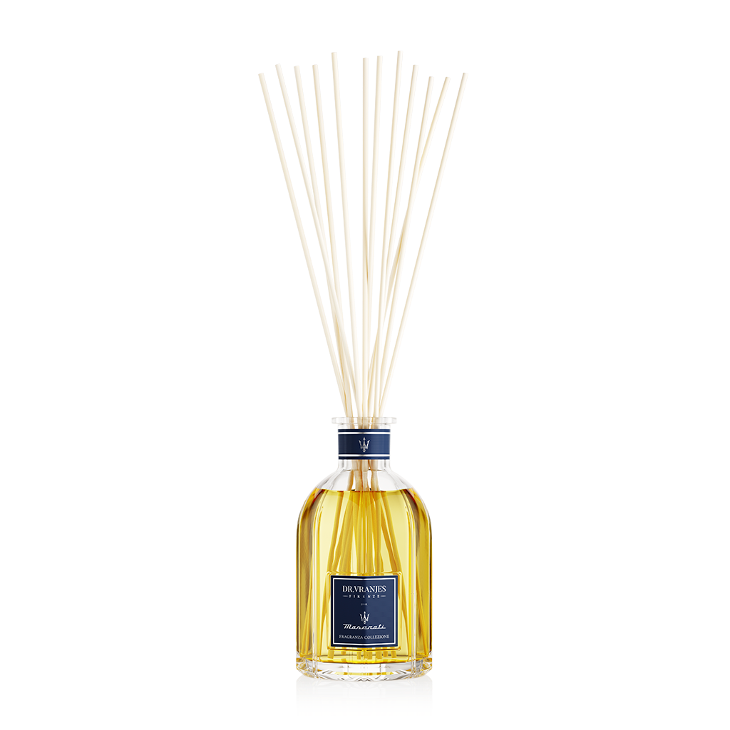 Eclectic Dr Vranjes Maserati reed diffuser in a glass bottle with natural sticks against a black background
