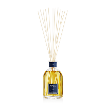 Eclectic Dr Vranjes Maserati reed diffuser in a glass bottle with natural sticks against a black background