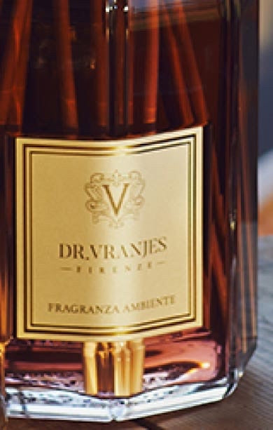 Eclectic Dr Vranjes Melograno diffuser refill bottle with a gold label and rich amber fragrance liquid