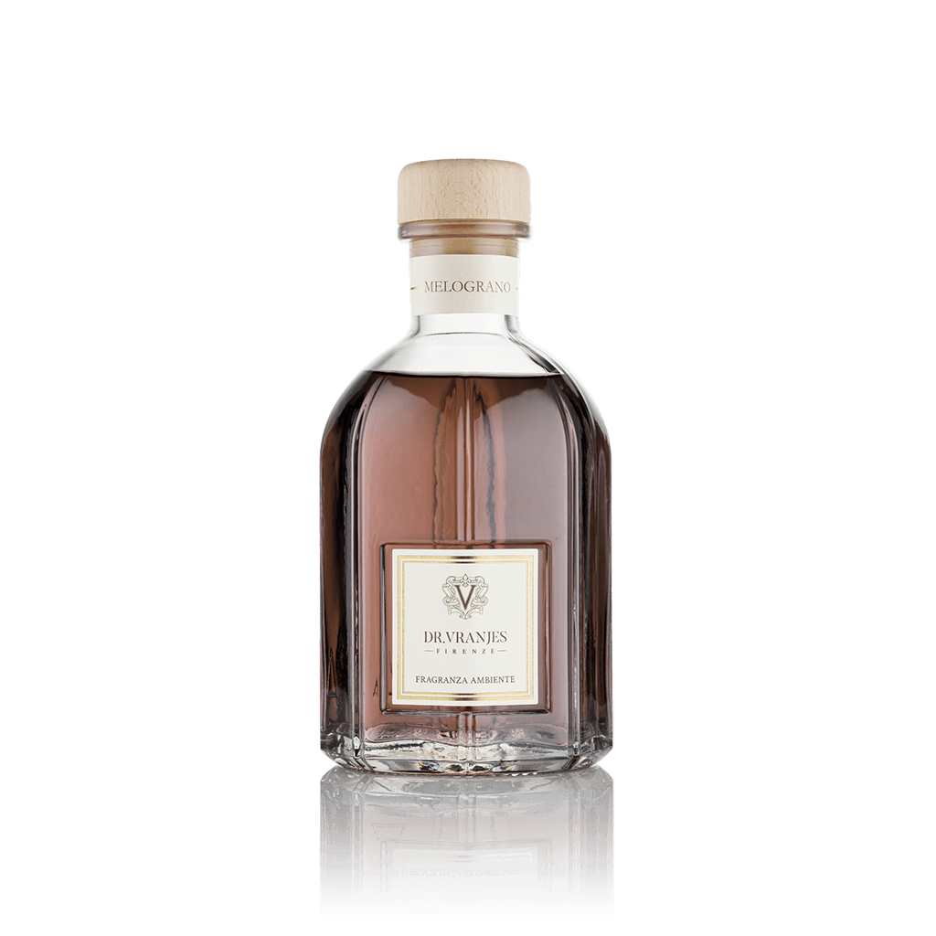 Eclectic Dr Vranjes Melograno reed diffuser in a clear glass bottle with a wooden cap against a black background.