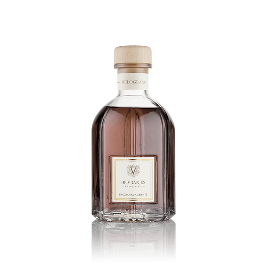 Eclectic Dr Vranjes Melograno reed diffuser in a clear glass bottle with a wooden cap against a black background.
