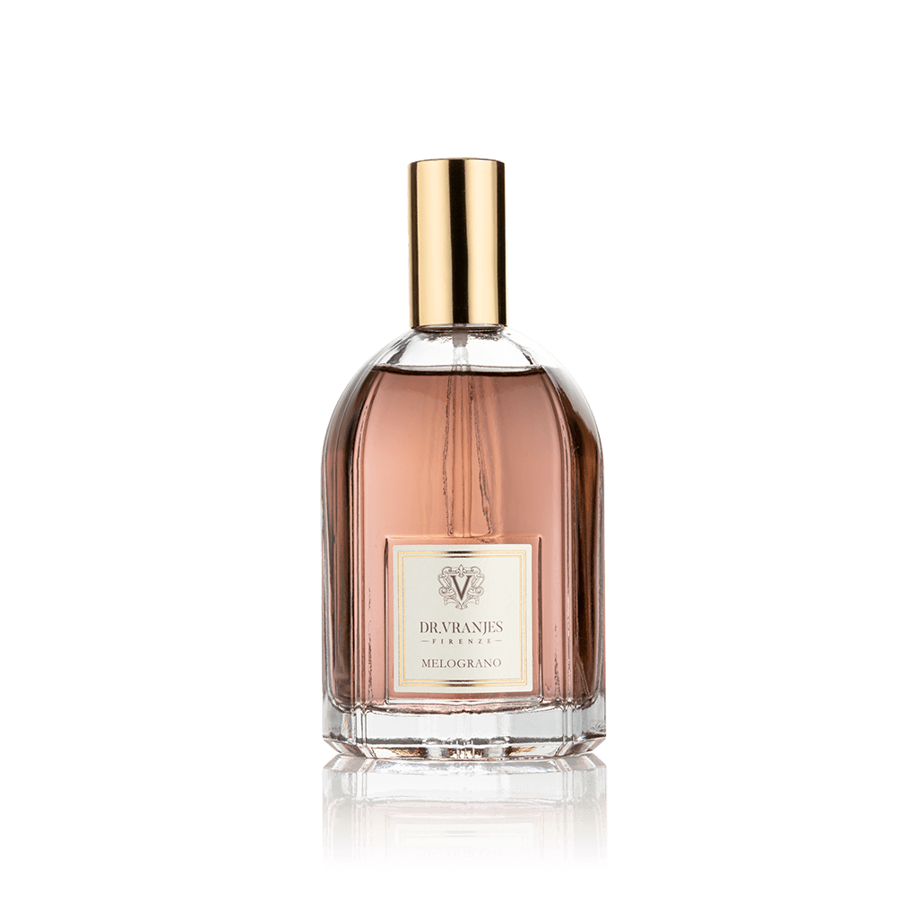 Eclectic Dr. Vranjes Melograno room spray in a clear glass bottle with a gold cap against a black background.