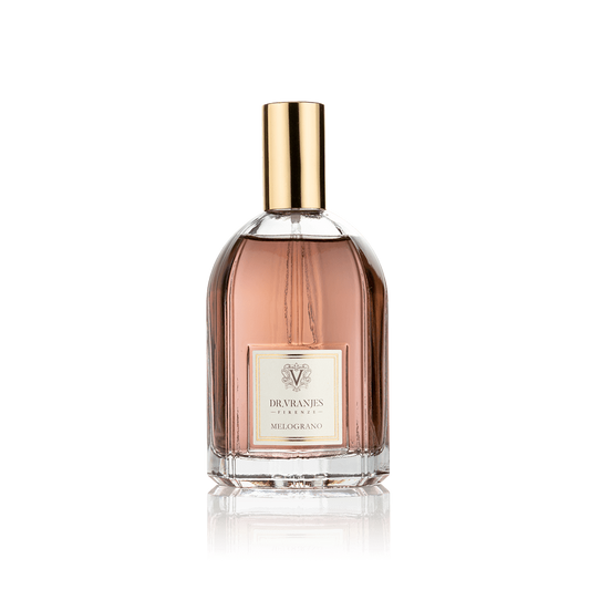 Eclectic Dr. Vranjes Melograno room spray in a clear glass bottle with a gold cap against a black background.