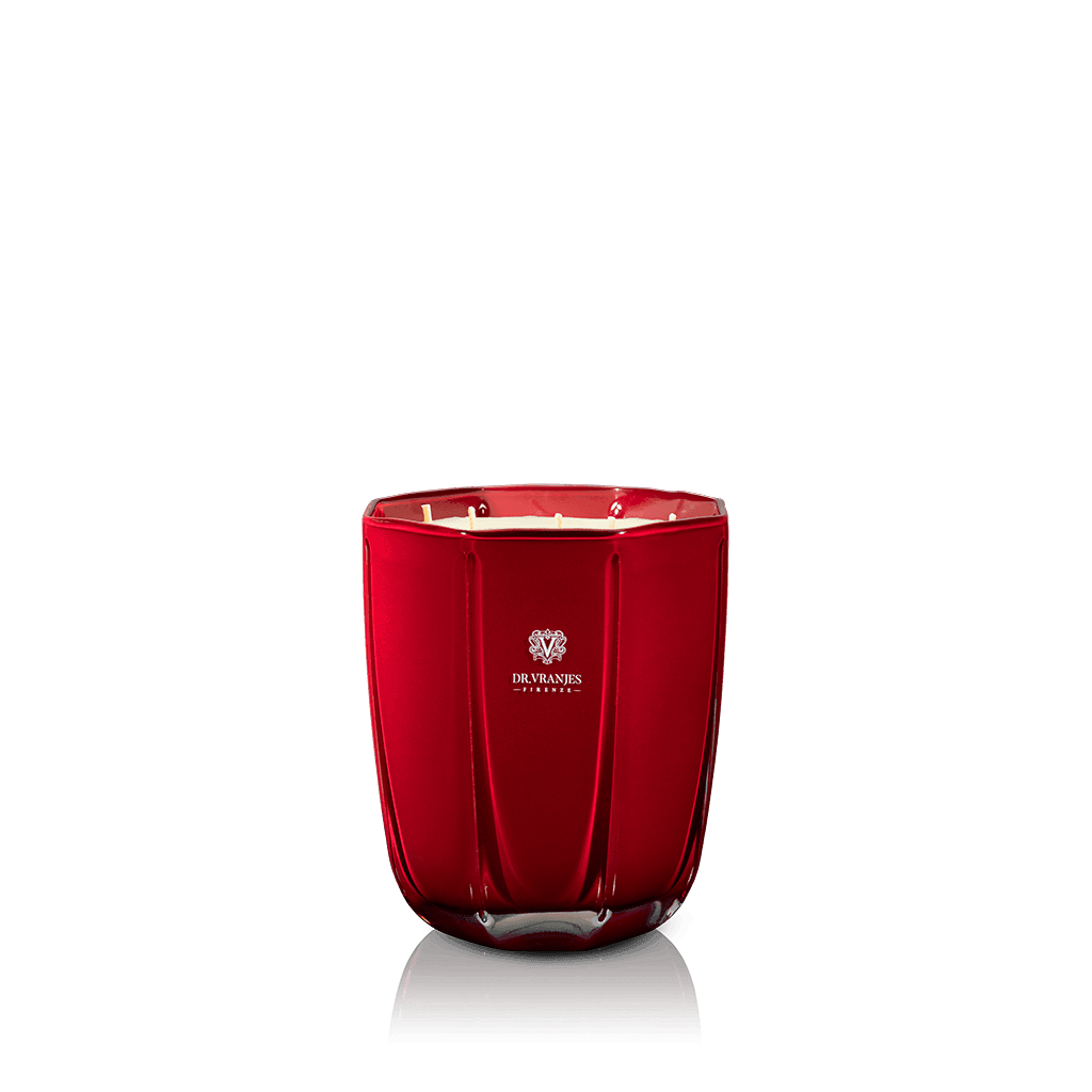 Eclectic Dr. Vranjes Melograno scented candle in a decorative tourmaline-coloured glass vase on a black background.