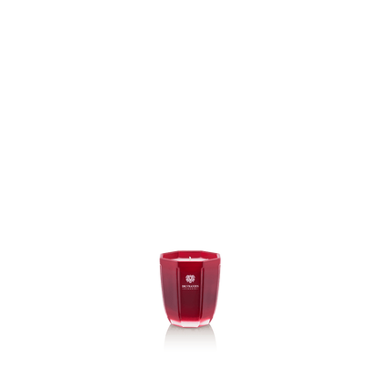 Eclectic Dr Vranjes Melograno scented candle in a tourmaline-coloured glass vase with a faceted design.