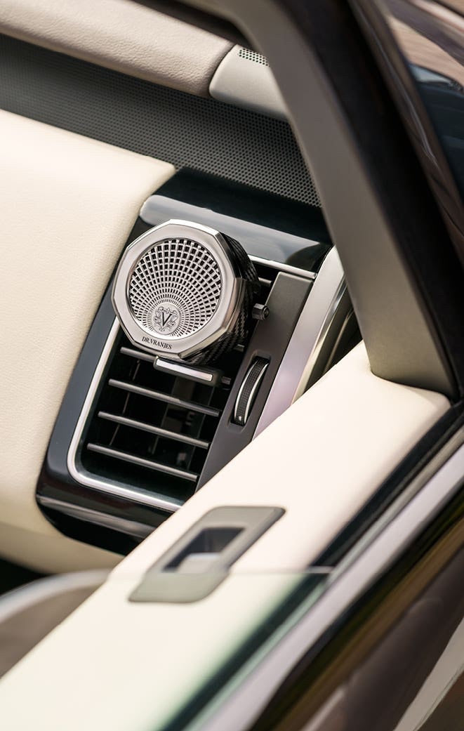 Eclectic Dr. Vranjes nickel car air vent diffuser with an octagonal design clipped into a luxury car interior.