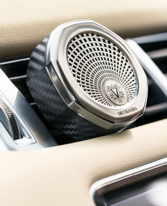 Eclectic Dr. Vranjes nickel car diffuser with octagonal design clipped onto a car air vent.