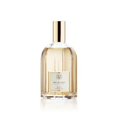 Eclectic Dr. Vranjes Rosa Tabacco room spray in a clear glass bottle with a gold cap against a black background.