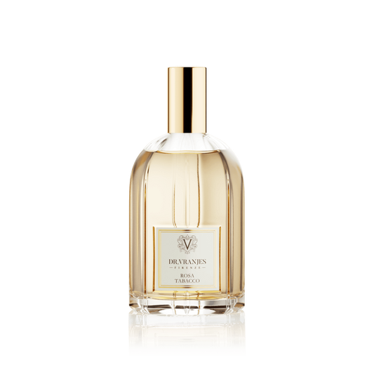 Eclectic Dr. Vranjes Rosa Tabacco room spray in a clear glass bottle with a gold cap against a black background.