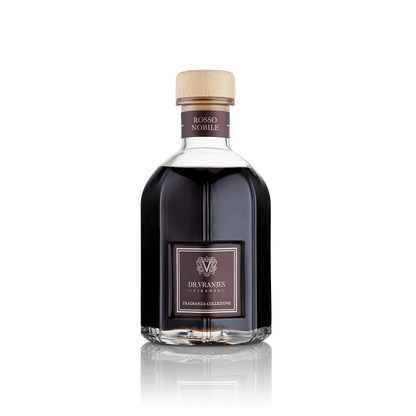 Eclectic Dr Vranjes Rosso Nobile reed diffuser in a signature glass bottle with a light wood cap on black background