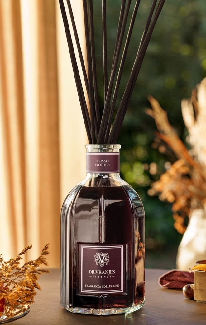 Eclectic Dr Vranjes Rosso Nobile reed diffuser in a glass bottle with dark fragrance and long black diffuser sticks.