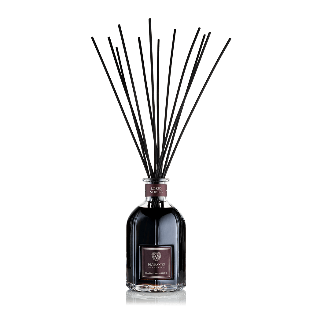 Eclectic Dr Vranjes Rosso Nobile reed diffuser in a glass bottle with black fragrance sticks against a black background.