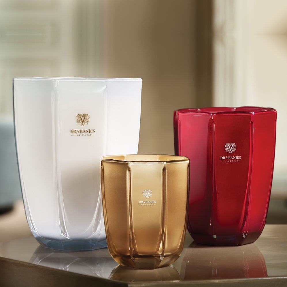 Eclectic Dr. Vranjes Firenze scented candles in pearl, gold, and red glass vases with embossed brand logo
