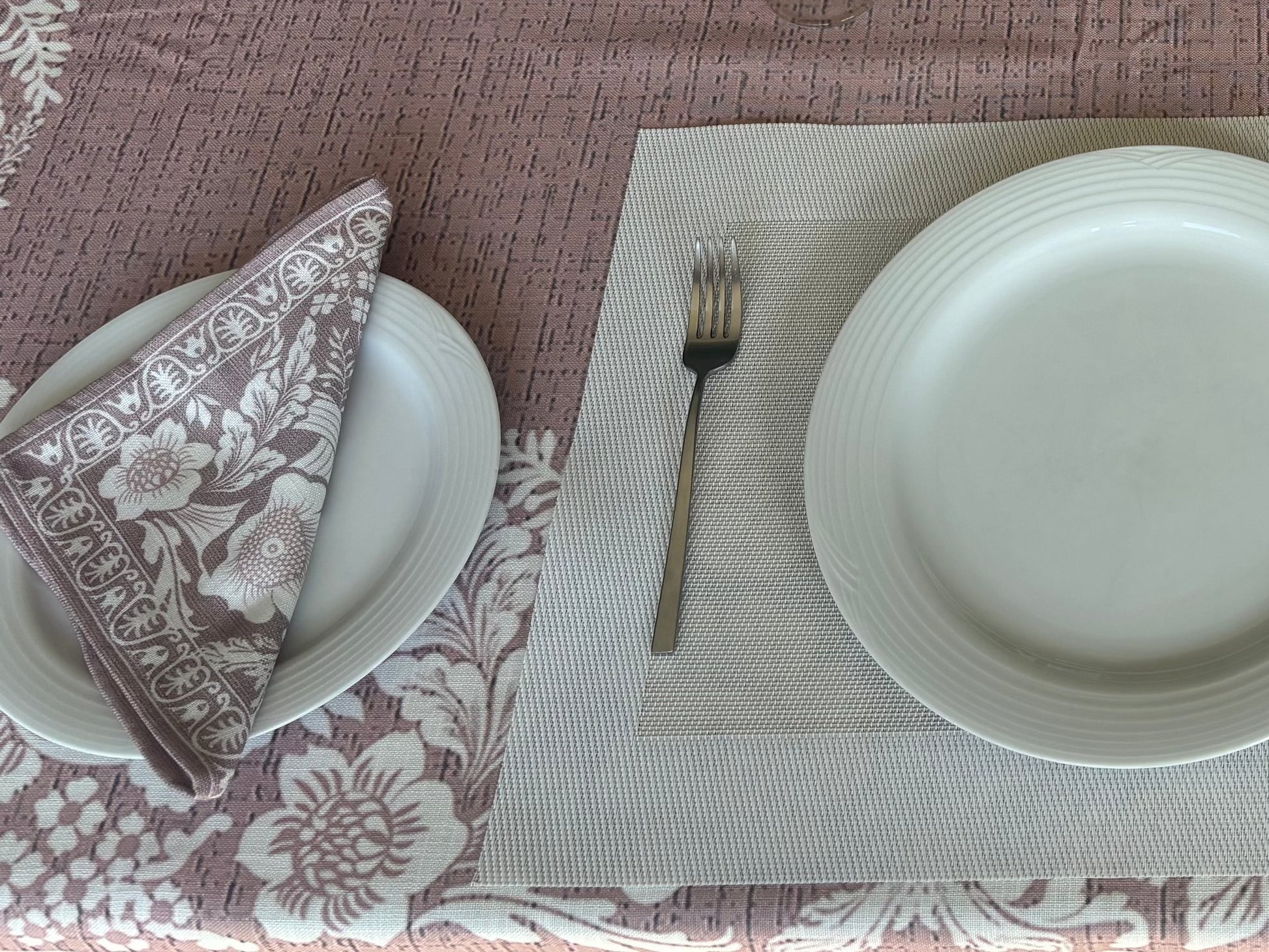 Eclectic floral dusty pink napkin set of 4 with white botanical motifs on a linen-look fabric table setting.