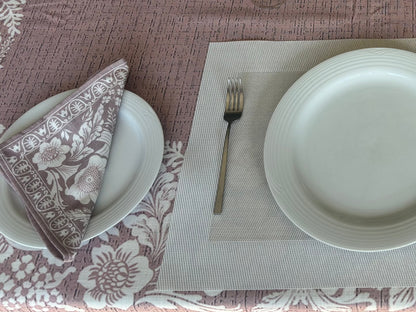 Eclectic floral dusty pink napkin set of 4 with white botanical motifs on a linen-look fabric table setting.
