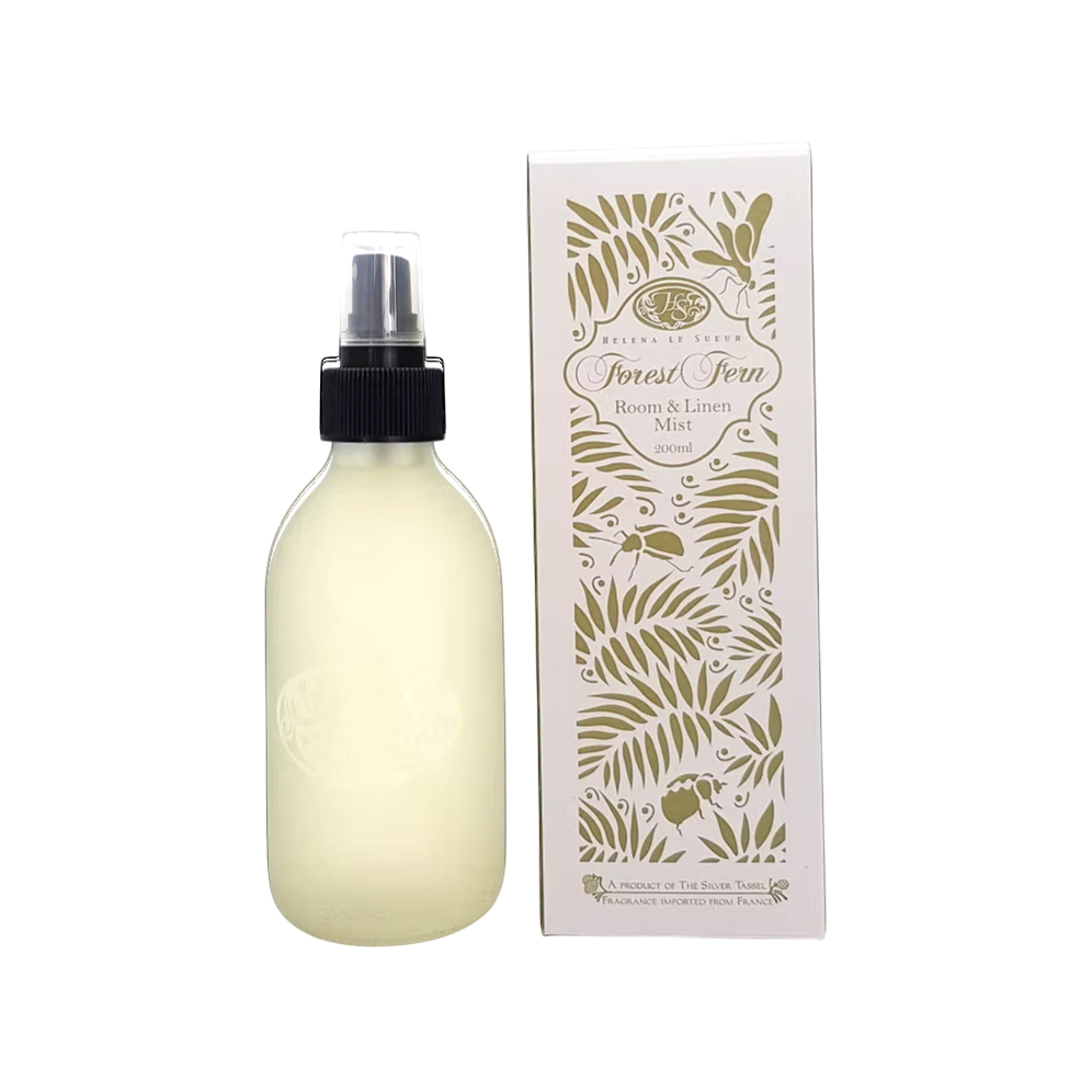 Eclectic Forest Fern room and linen mist in a frosted glass bottle next to its decorative botanical print box.