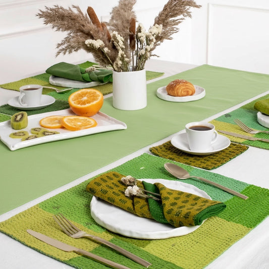 Eclectic Françoise Paviot anise green airlaid table runner roll styled on a dining table with place settings