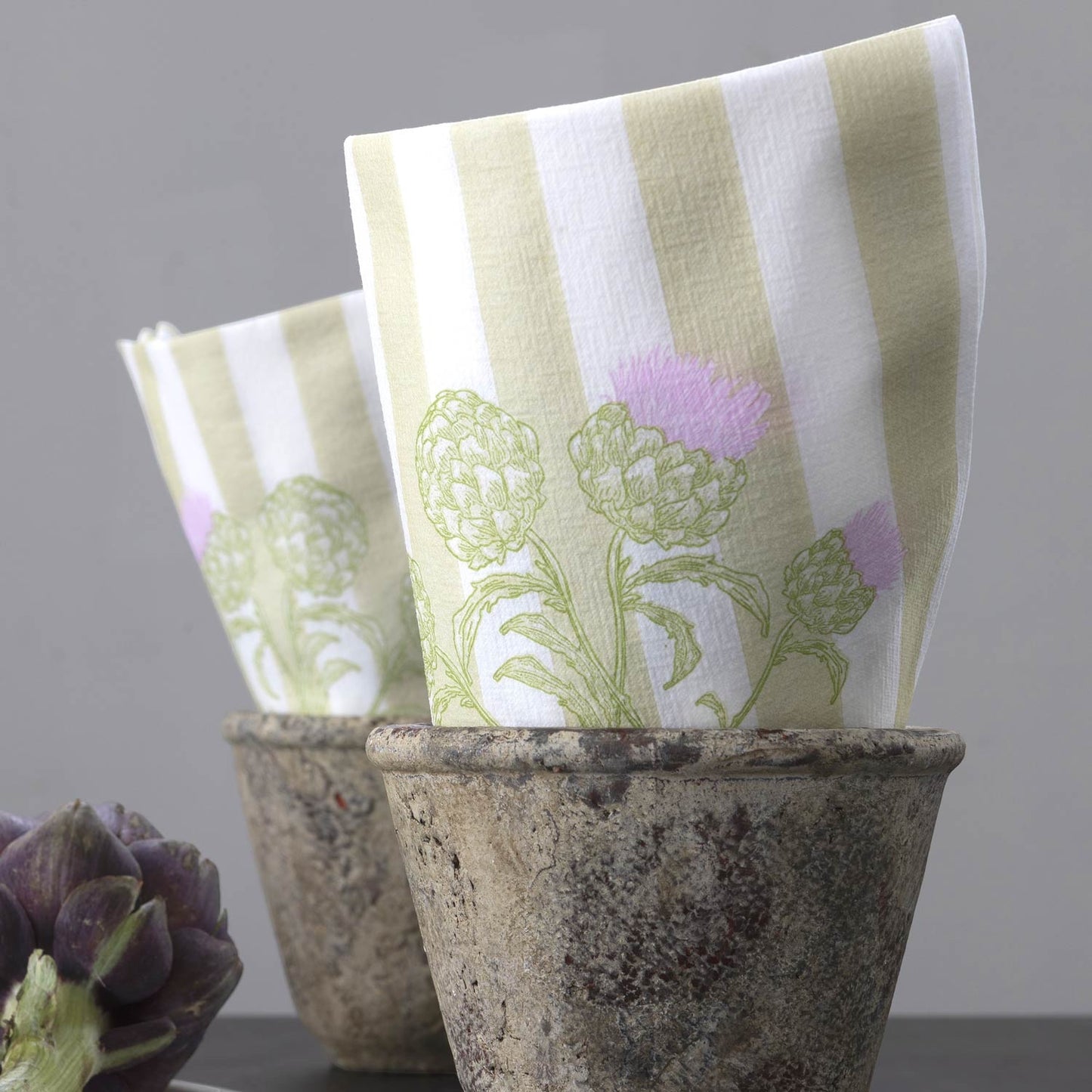 Eclectic Françoise Paviot Artichaut airlaid napkins with green botanical artichoke print and stripes in stone pots