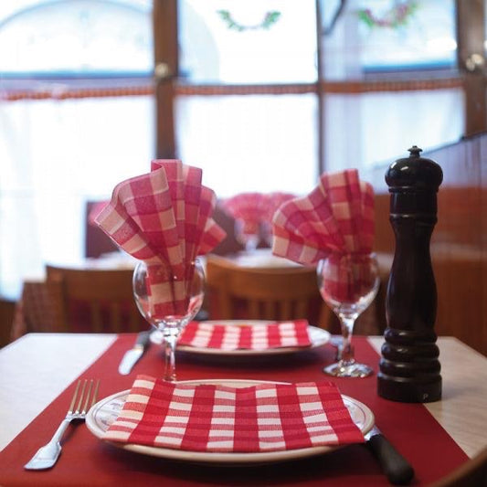 Eclectic Françoise Paviot Bistrot Rouge red and white gingham airlaid dinner napkins styled on a French bistro table.
