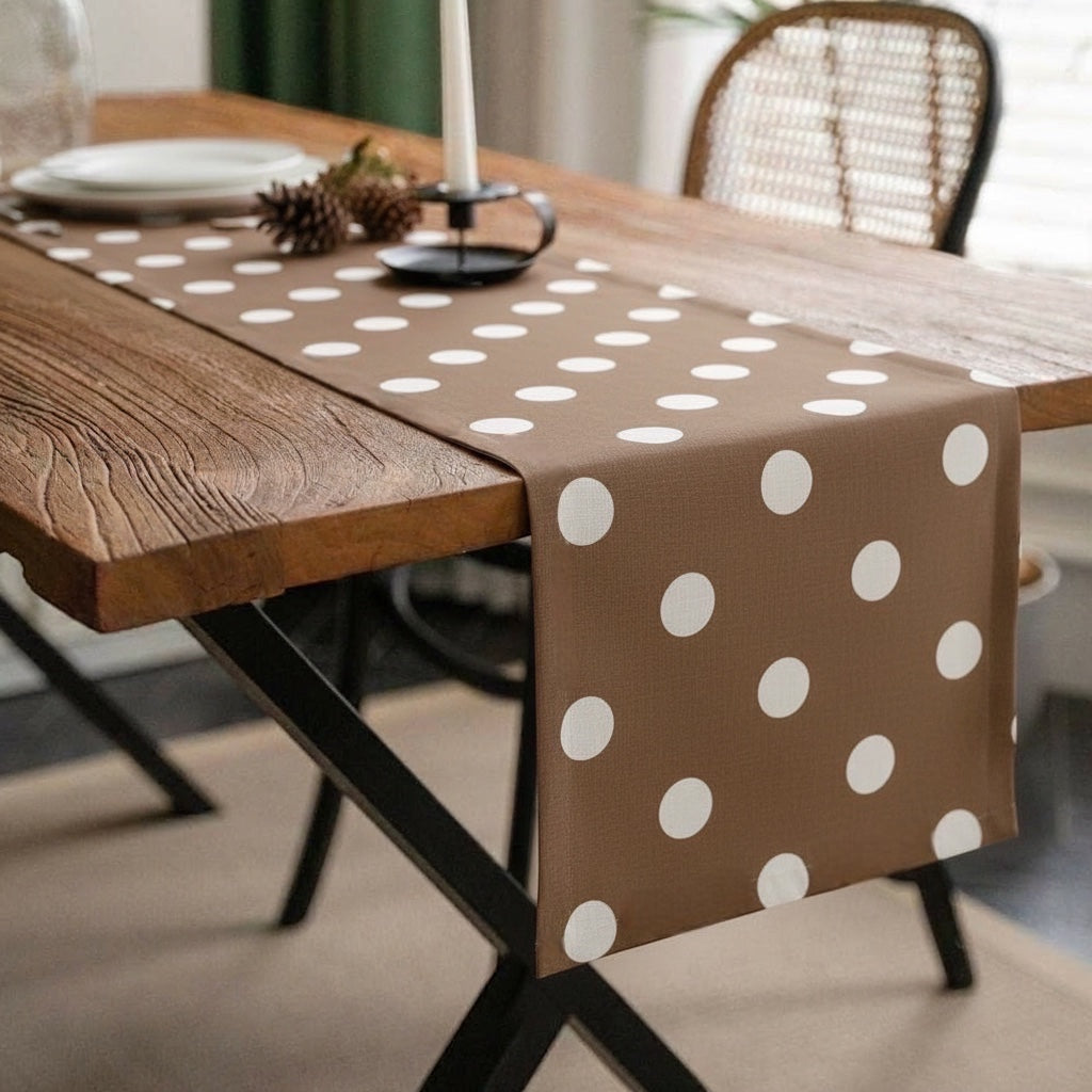 Eclectic Françoise Paviot brown airlaid table runner with white polka dots on a rustic wooden dining table