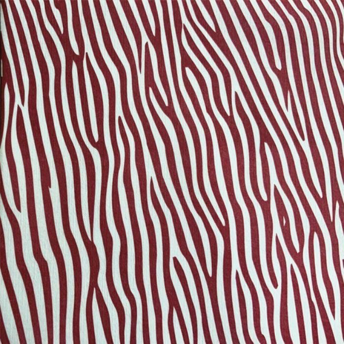 Eclectic Françoise Paviot Dune Terre airlaid dinner napkin featuring a deep red and white abstract zebra stripe pattern.