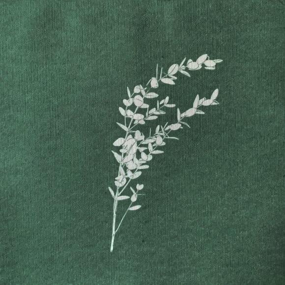 Eclectic Françoise Paviot eucalyptus dinner napkin in deep green airlaid material with white botanical branch print.